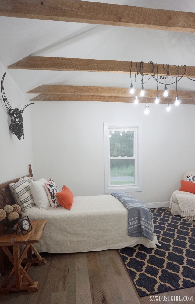 exposed beams in bedroom with vintage socket lights