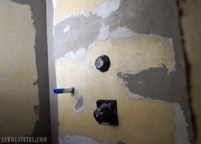 Installing waterproof panel shower walls.