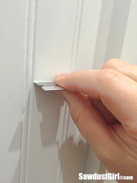 Use a razor blade to flatten bumpy paint finish