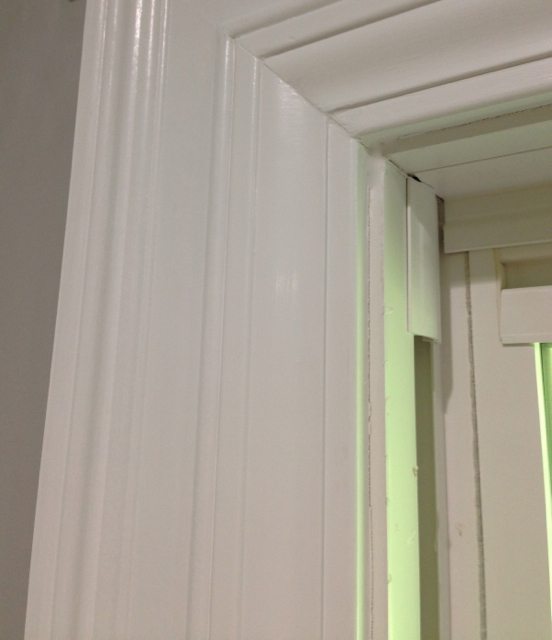 Wide door and window trim molding created by layering two styles of trim together.